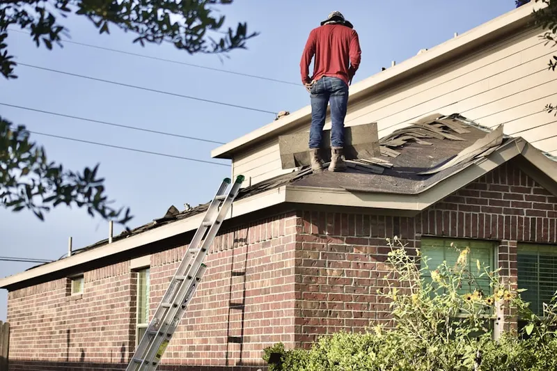 Professional roofer working on a residential roof in Pine Woods